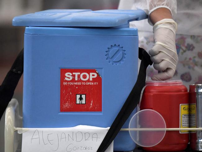 A health worker disposes a syringe after administering the AstraZeneca vaccine. Picture: AFP