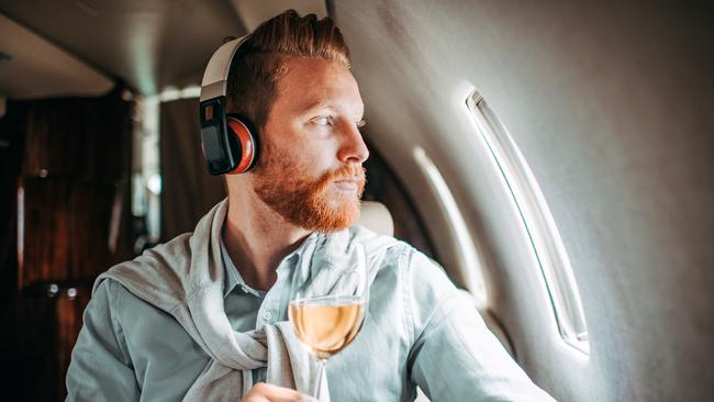 Limit the booze that you have on a flight as it can dehydrate your body. Picture: iStock