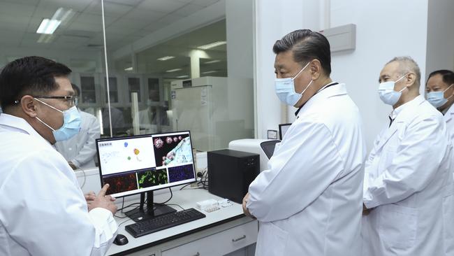 Chinese President Xi Jinping talks to a medical staff member during his visit to the Academy of Military Medical Sciences in Beijing on March 2.