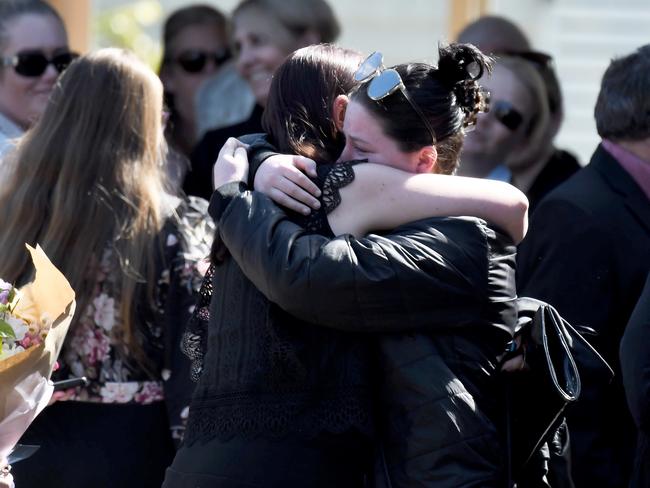 Mourners embrace outside the church. Picture: BACKGRID via NCA NewsWire