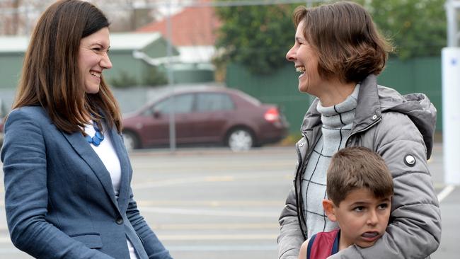 Liberal candidate Nicolle Flint, who appears in the box seat to hold Boothby, speaks with Sharon and Patrick Harvey.