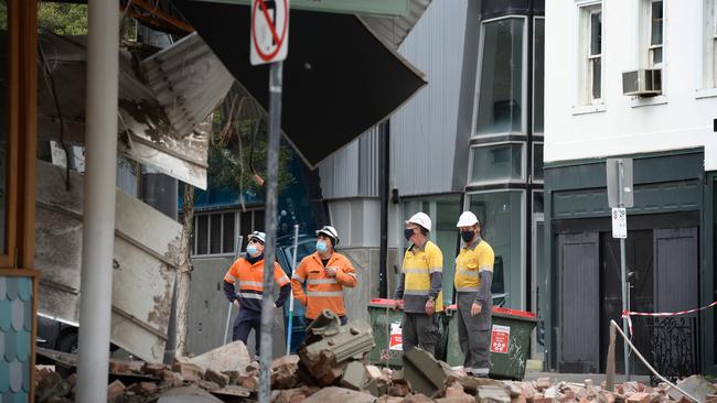 Workers assess the damage at Betty’s Burgers after Melbourne’s earthquake on Wednesday morning. Picture: Andrew Henshaw