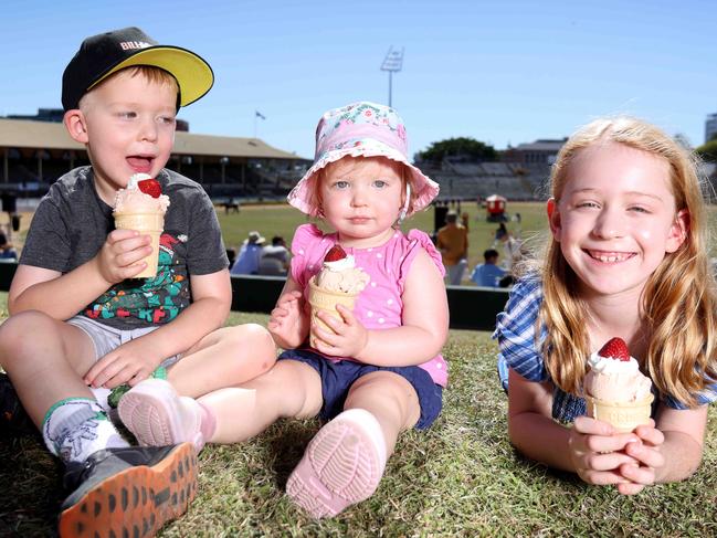 Caleb Schipper 4 yrs, Lara  Schipper 18 months and Kate Schipper 7 yrs from Bellbird Park, eating Strawberry SundaeÃs on the hill. Crowd, Strawberry sundae and dagwood dog contest photos, Ekka Bowen Hills, on Sunday 20th August 2023 - Photo Steve Pohlner