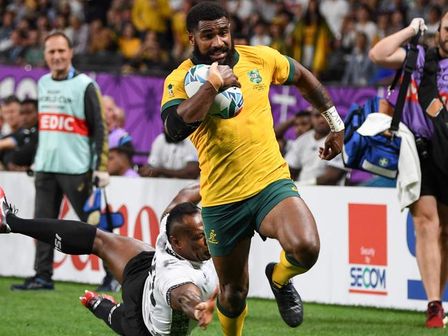 Marika Koroibete flying down the wing for the Wallabies. Picture: AFP