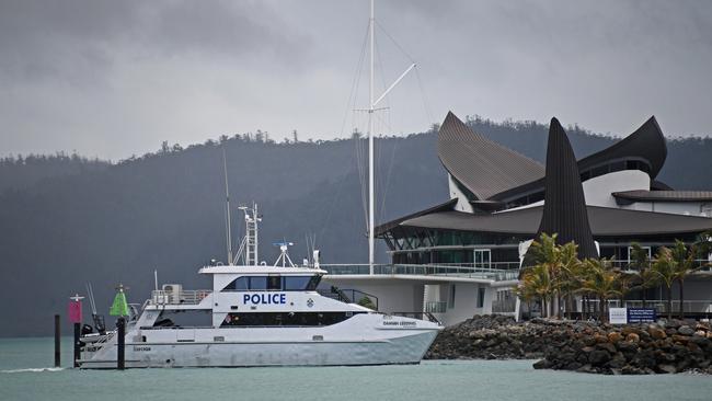 The police boat returns to Hamilton Island from the crash site at Hardy Reef on the Great Barrier Reef.