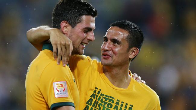 Tim Cahill celebrates with Tomi Juric after a big win for the Socceroos.