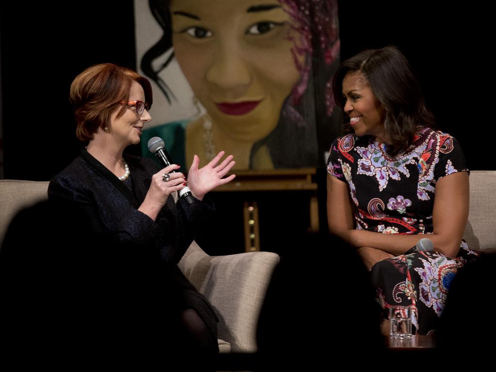 US First Lady Michelle Obama and former Australia Prime Minister Julia Gillard, left, take part in a question and answer session in front of an audience of students in the main hall of Mulberry School for Girls in east London, Tuesday, June 16, 2015. Picture: AAP