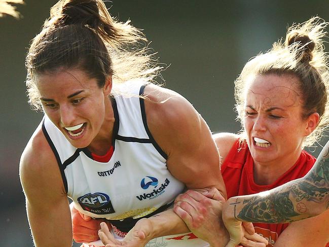 MELBOURNE, AUSTRALIA - FEBRUARY 10:  Daisy Pearce of the Demons tackles Angela Foley of the Crows during the round two AFLW match between the Melbourne Demons and the Adelaide Crows at Casey Fields on February 10, 2018 in Melbourne, Australia.  (Photo by Michael Dodge/Getty Images)