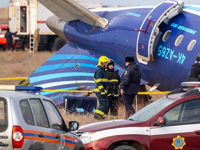 Emergency specialists work at the crash site of an Azerbaijan Airlines passenger jet near the western Kazakh city of Aktau on December 25, 2024. The Embraer 190 aircraft was supposed to fly northwest from the Azerbaijani capital Baku to the city of Grozny in Chechnya in southern Russia, but instead diverted far off course across the Caspian Sea. It crashed on December 25, 2024 near the city of Aktau in Kazakhstan. (Photo by Issa Tazhenbayev / AFP)