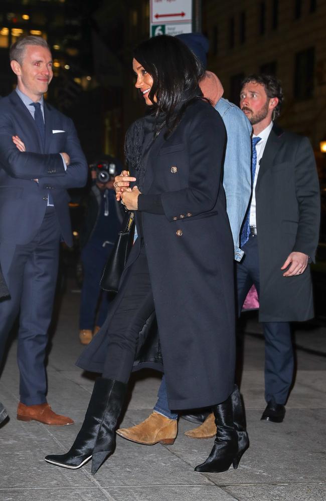 The Duchess of Sussex wore a navy coat and black knee high boots. Picture: Felipe Ramales / SplashNews.com 