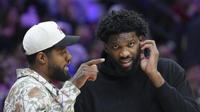 PHILADELPHIA, PENNSYLVANIA - NOVEMBER 2: Paul George #8 of the Philadelphia 76ers talks to Joel Embiid #21 during a timeout in the game against the Memphis Grizzlies in the first half at the Wells Fargo Center on November 2, 2024 in Philadelphia, Pennsylvania. NOTE TO USER: User expressly acknowledges and agrees that, by downloading and/or using this photograph, user is consenting to the terms and conditions of the Getty Images License Agreement. (Photo by Mitchell Leff/Getty Images)