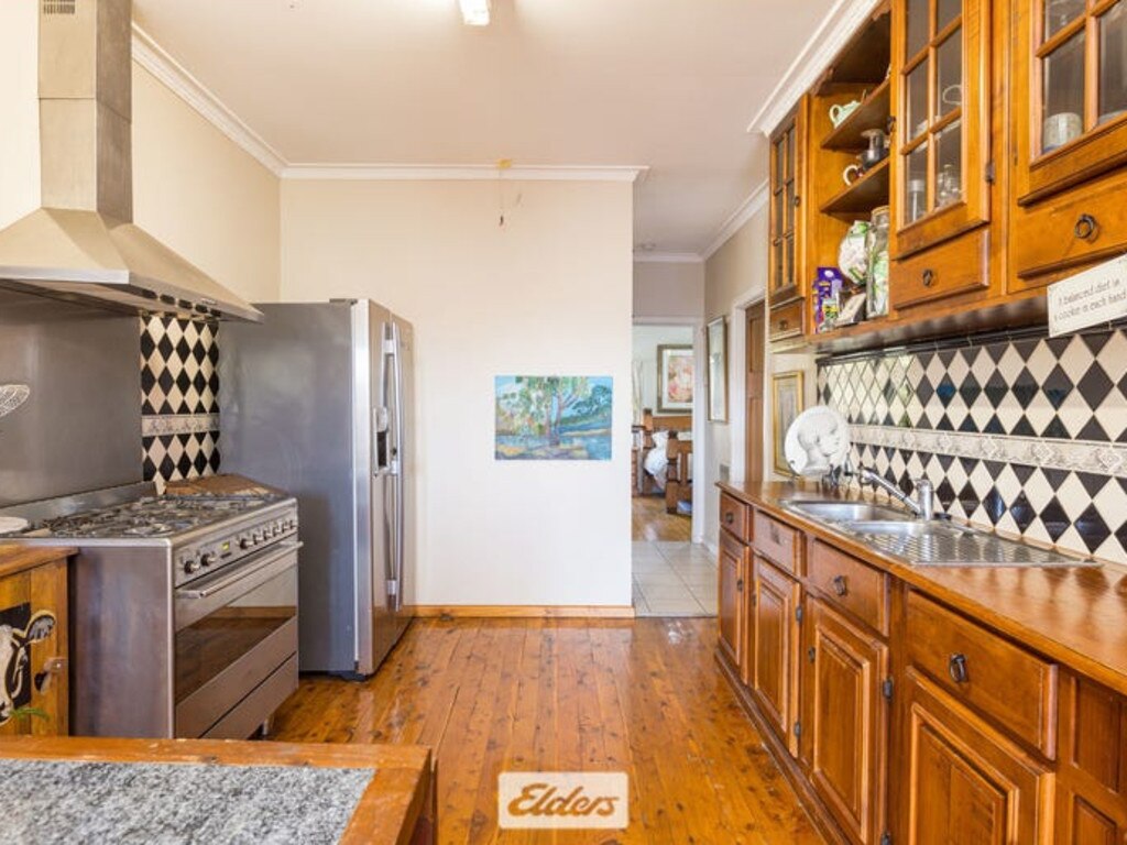 The kitchen is full of country charm, with a huge stainless stove.