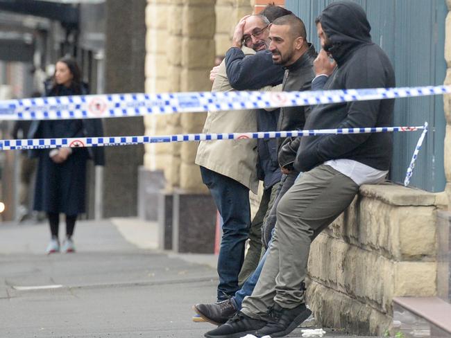 Family and friends outside the apartment block were distraught. Picture: Jeremy Piper