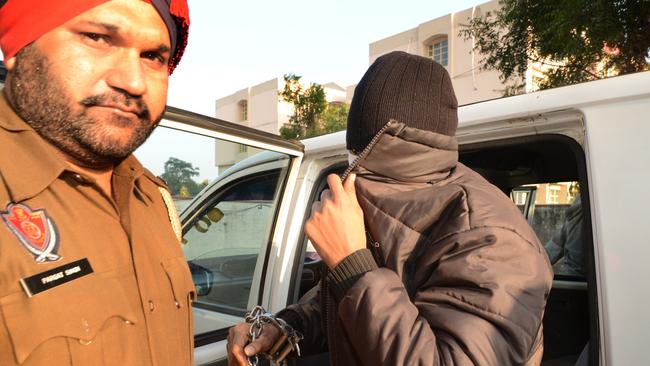 Puneet Puneet arrives under police escort at an earlier court date.
