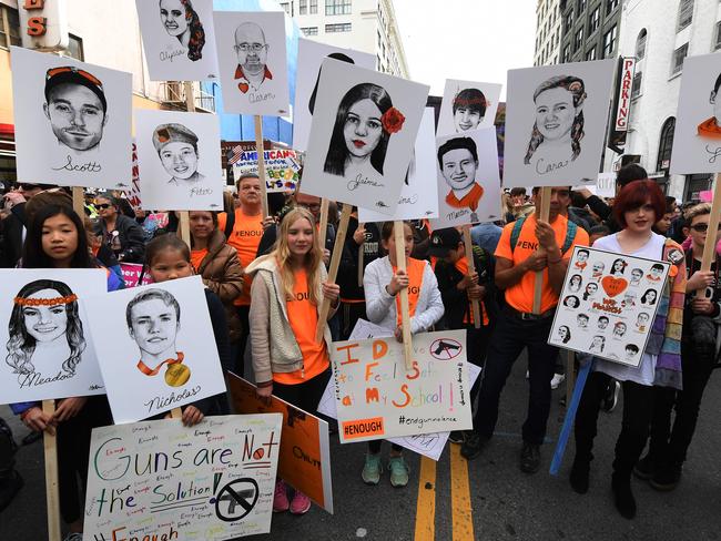 Portraits of victims of Marjory Stoneman Douglas High School shootings as students protest for tighter gun laws. Picture: AFP