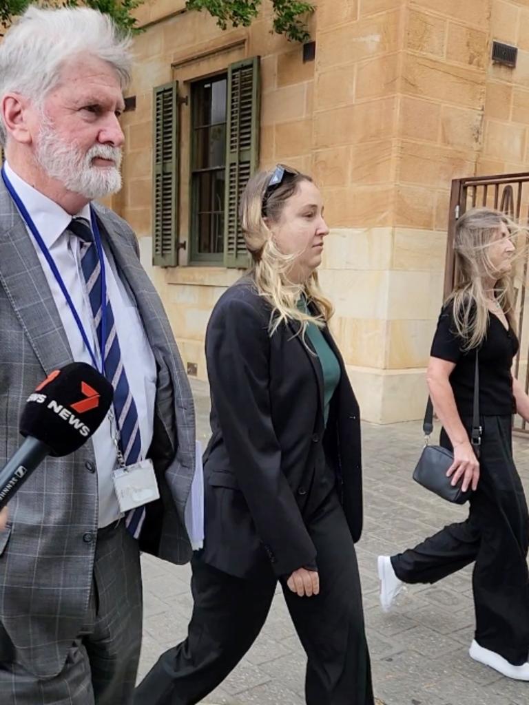 Hannah Neale, centre, charged with child sexual abuse, leaves the Adelaide Magistrates Court with her lawyer. Picture: Leah Smith