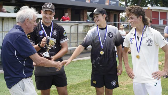 Craig Shield: John Craig hands the trophy to Brunswick coach Luke Money and co-captains Zane Attard and Keir Lucas. Picture: Valeriu Campan