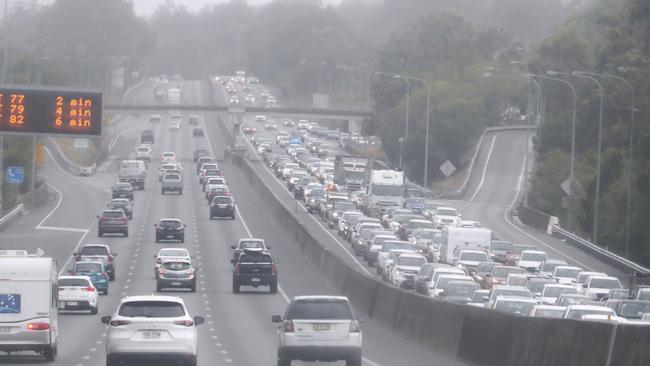 Scenes on the M1 at Nerang where a fallen tree caused delays as wild weather lashed The Gold Coast. Photograph: Jason O'Brien