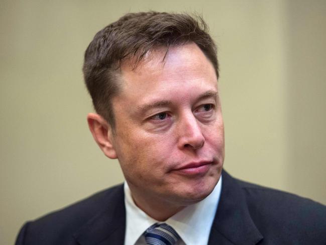 (FILES) In this file photo taken on January 23, 2017 CEO Elon Musk listens to US President Donald Trump speak during a meeting with business leaders in the Roosevelt Room at the White House in Washington, DC. - Tesla Motors dropped in early trading on August 20, 2018 due to rising doubts about Chief Executive Elon Musk's plans to take the electric carmaker private. Shares fell 2.6 percent to $297.55 about 20 minutes into trading, continuing the company's downward trajectory after Musk surprised markets on August 7 by announcing on Twitter he wanted to take Tesla private. (Photo by NICHOLAS KAMM / AFP)