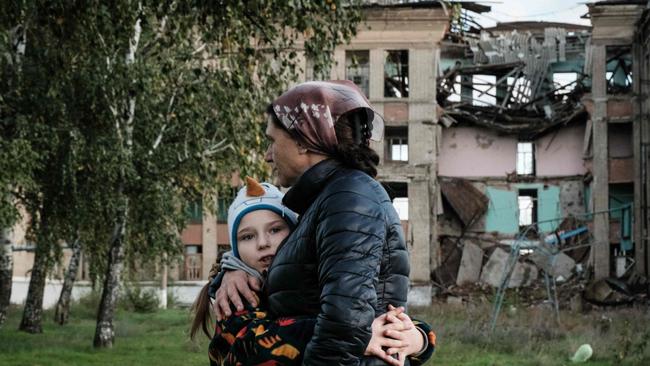 Olga Srednyakova, 51, a single mother of eight children, hugs youngest daughter Vera, 8, in Konstantinovka in the Donetsk region of Ukraine.