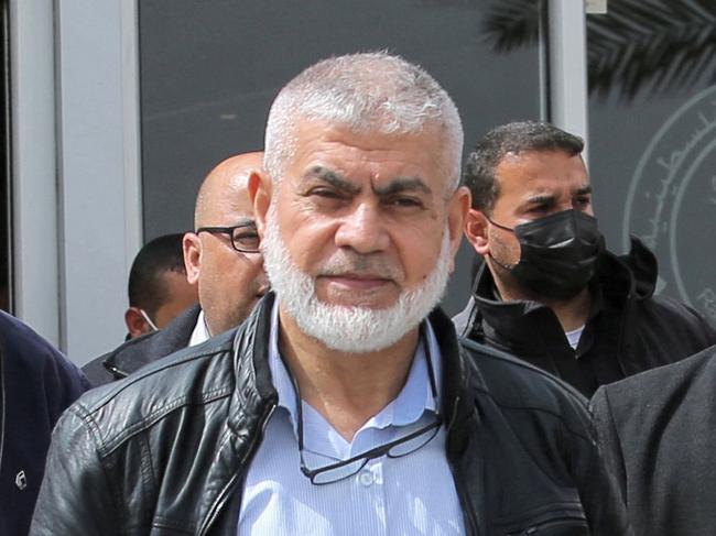 (FILES) Hamas leaders Rawhi Mushtaha (C) and Khalil Al-Hayya (R) walk outside the VIP hall at the Rafah border crossing with Egypt in the southern Gaza Strip on March 15, 2021. The Israeli military said on October 3, 2024, that a strike three months ago killed three senior Hamas leaders in Gaza, including Rawhi Mushtaha, the head of the Hamas government in the Gaza Strip, where the army has been battling the Palestinian militants for nearly a year. (Photo by SAID KHATIB / AFP)