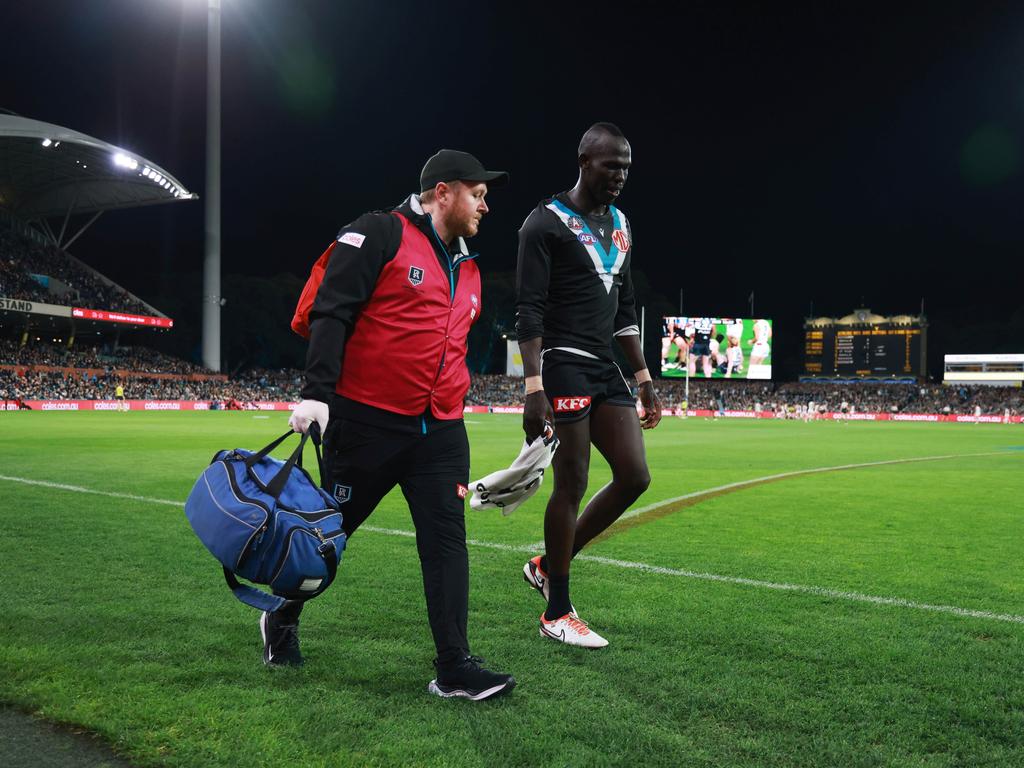 Aliir Aliir of the Power comes off injured. (Photo by James Elsby/AFL Photos via Getty Images)