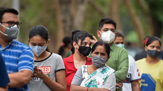 People line up to get the COVID-19 coronavirus vaccine outside Moti Lal Nehru Medical College in Allahabad on May 3, 2021. (Photo by Sanjay KANOJIA / AFP)