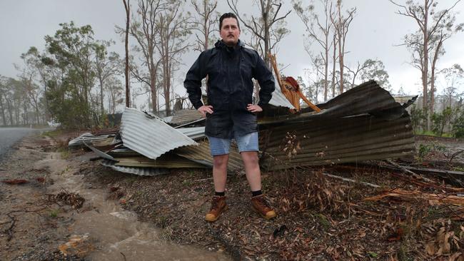 Journalist Charlton Hart keeps an eye on the storm clouds after the recent flood broke all records in the Kriedman Rd area. Picture Glenn Hampson