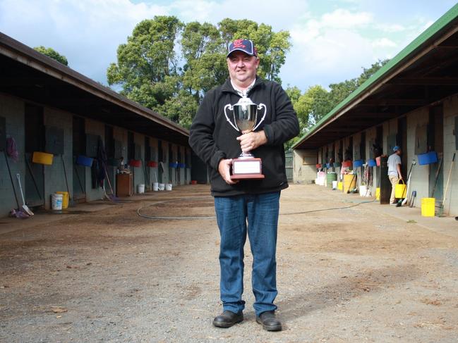 Toowoomba horse trainer Kevin Kemp holds the Weetwood Handicap trophy at his stables. Kemp won the 2014 Weetwood with Typhoon Red and had Kempelly run second. That achievement saw Kemp take out The Chronicle-Clear Mountain Fairview Trainer of the Month for April.