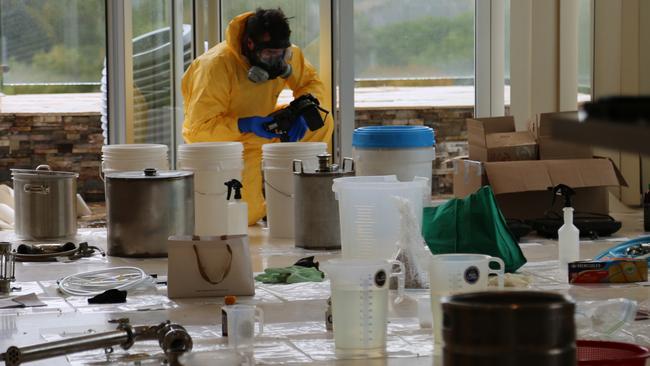 Police dismantle and document the drug lab in a Strathfield unit on Friday. Picture: NSW Police