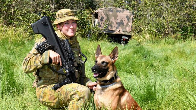 North Queensland Warfighter multi-nation military exercises in the Ingham region. Soldiers at the 'El Ingham' aerodrome. Corporal Zoey Plater with Buddy from the 1MP Battalion. Picture: Evan Morgan