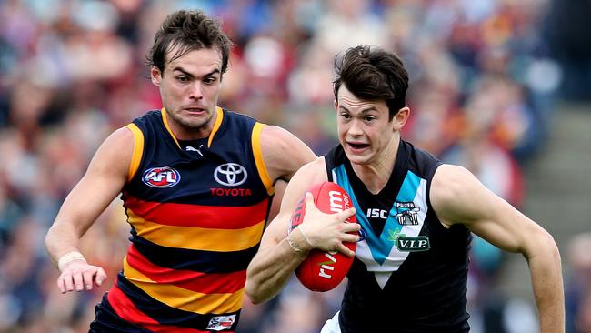 AFL – Adelaide Crows v Port Adelaide Power in Showdown 35 at AAMI Stadium. Jasper Pittard on the move towards goal with Lewis Johnston chasing. PIC SARAH REED.