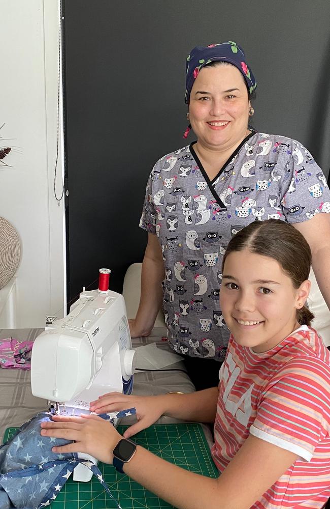 Dr Maria Boulton (from Family Doctors Plus) with daughter Lara who made scrub caps to donate to the clinic.