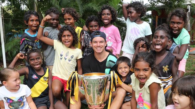 Daniel with kids from the Pirlangimpi primary school during its visit to the Tiwi's. Picture: Michael Klein