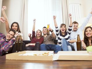 Group of friends watching TV match and cheering. Picture: iStock