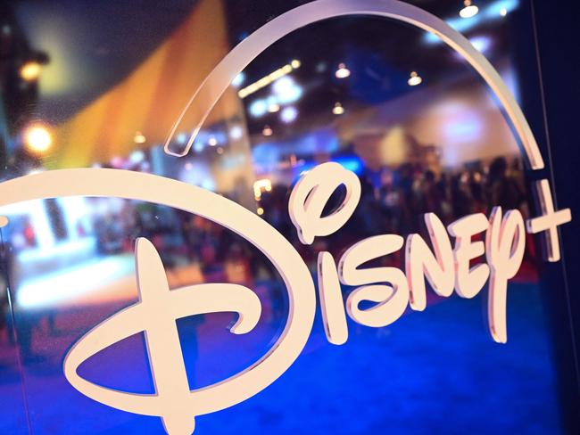 (FILES) Fans are reflected in Disney+ logo during the Walt Disney D23 Expo in Anaheim, California on September 9, 2022. Disney reported on August 7, 2024, better revenues than anticipated in the most recent quarter, atop a first profit in its streaming business, while its theme parks came under pressure. The company saw revenues of $23.2 billion, beating projections of $23.1 billion, while overall profits reached $2.6 billion. (Photo by Patrick T. FALLON / AFP)