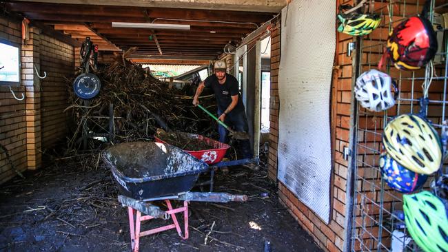 A resident cleans a flood-damaged house in Taree. Picture: Roni Bintang/Getty Images