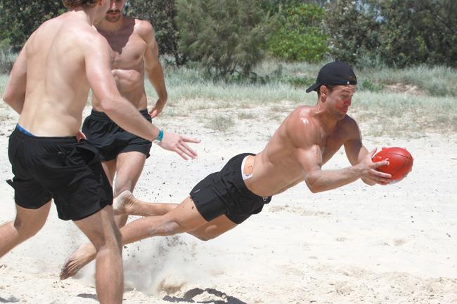 The Southport Sharks VFL team during a preseason training camp at Tallebudgera Beach. Picture: Mike Batterham. Rhys Clark dives with the football. Picture: Mike Batterham