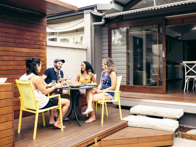 dt home gardening Dale Vine's Outdoor Reno Guide Group of friends enjoying lunch, talking and smiling on wooden deckingpage 22 pic credit: Johnny Greig