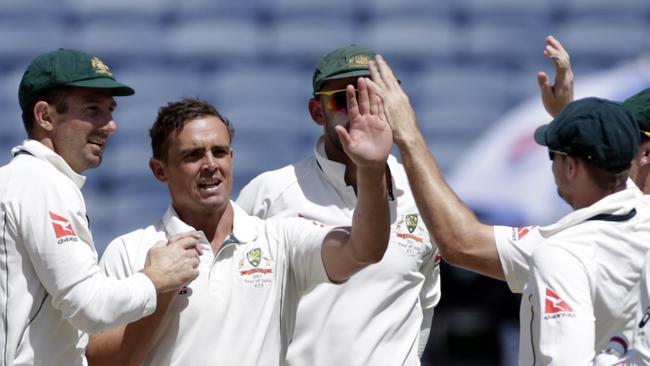 Australia's Steve O'Keefe, second left, and Nathan Lyon celebrate after Murali Vijay's wicket during third day of the first cricket test match against India in Pune, India, Saturday, Feb. 25, 2017. (AP Photo/Rajanish Kakade)