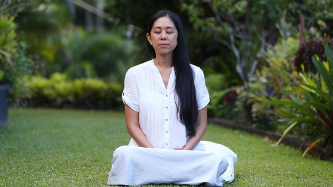 Transcendental Meditation is growing in popularity among Cairns residents seeking a more relaxed way of living. Certified Transcendental Meditation Teacher Treya Yew Ling Tan meditates in her Freshwater garden. Picture: Brendan Radke