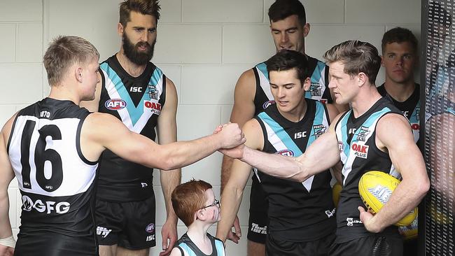 Ollie Wines (left) and Tom Jonas wish each other well before leading Port Adelaide out to battle for the round 23 home clash against Fremantle. Picture: SARAH REED