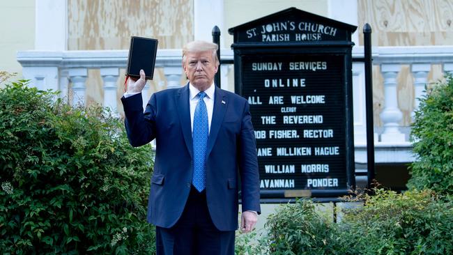 US President Donald Trump holds a Bible while visiting St John's Church across from the White House after the area was cleared of people protesting the death of George Floyd.