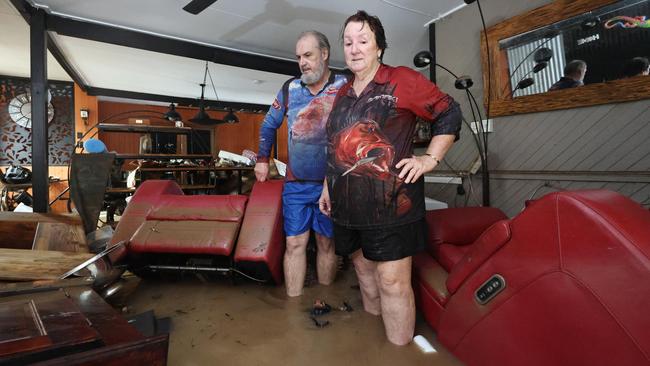 David and Tracy Ebert look for items to salvage from the lounge room, after flood water inundated their Cardwell home overnight. Picture: Brendan Radke