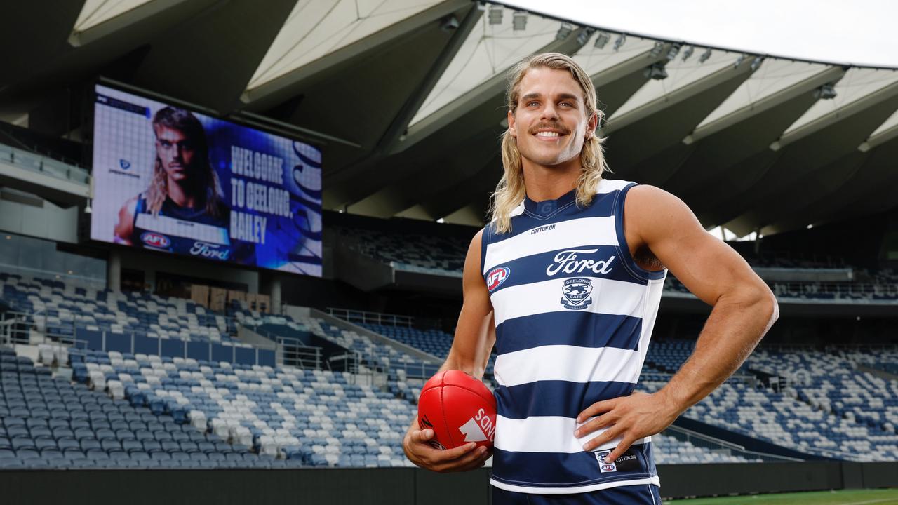 Bailey Smith proudly dons his new Geelong Cats jersey at GMHBA Stadium after being traded from the Western Bulldogs on Wednesday night. Picture: Michael Klein.