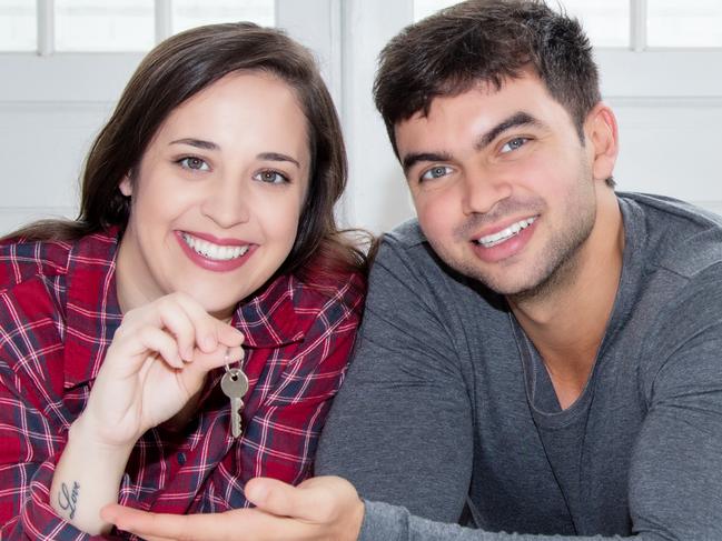 A couple holding keys after buying their first home and signing up to their first mortgage. Picture: iStock.