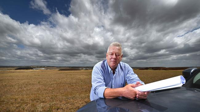 John Wagner, holding site plans, on the area at his Wellcamp airport where he wants to immediately build a Covid quarantine facility, at Toowoomba, west of Brisbane. Picture: Lyndon Mechielsen/ The Australian