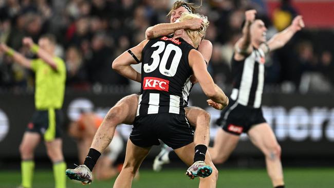 Collingwood stars Nathan Murphy and Darcy Moore react on the final siren. Picture: Getty Images