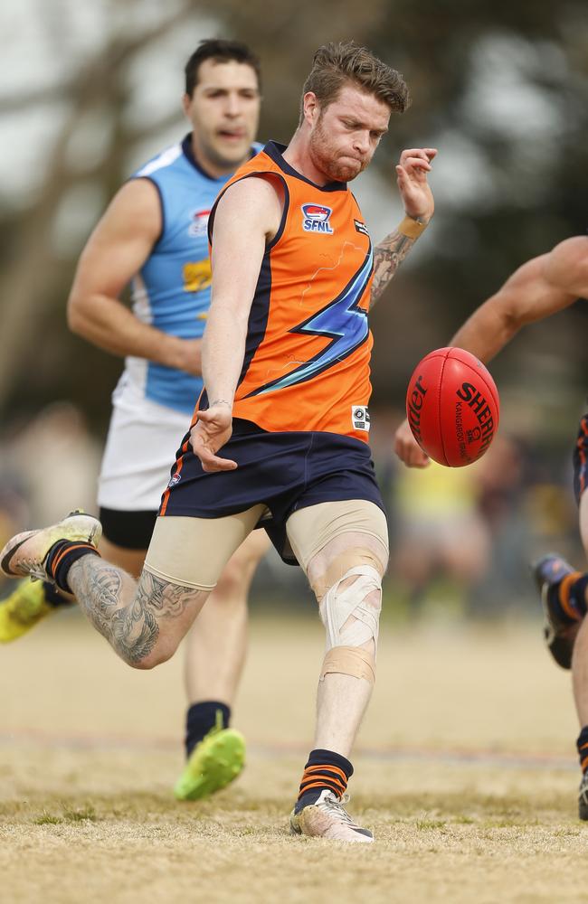 Lyndhurs’s Ben Hiam takes a kick in the grand final.