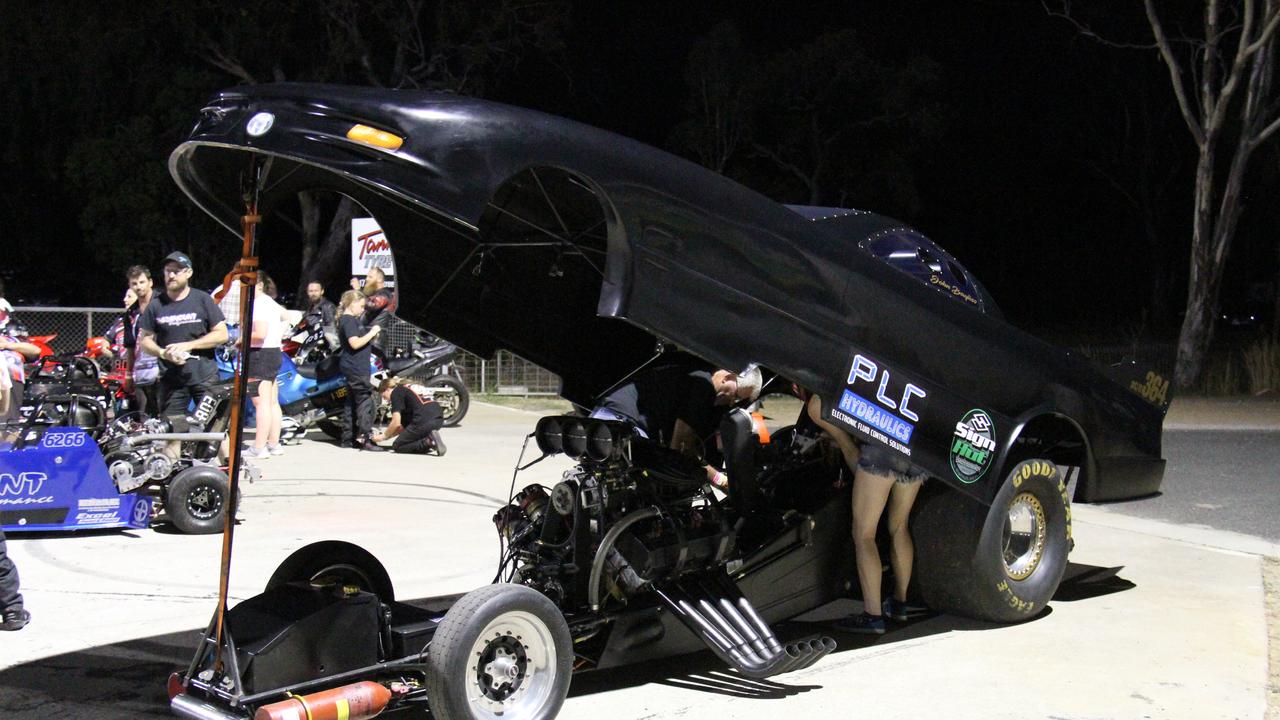 John Bayliss' team prepares his supercharged funny car for a demonstration pass at Benaraby dragway. Picture: Rodney Stevens
